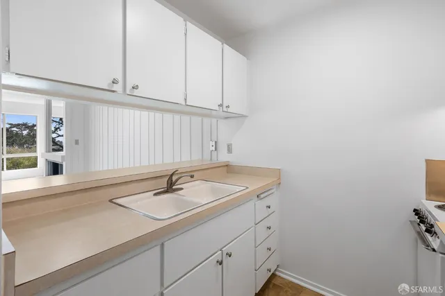 a bathroom with a sink and cabinets