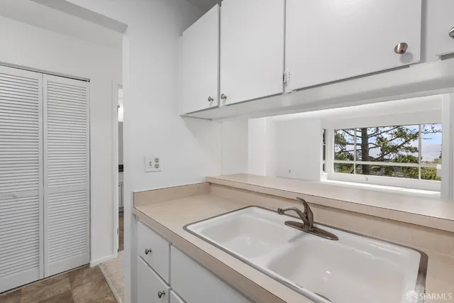 a bathroom with a granite countertop sink toilet a mirror and bathtub