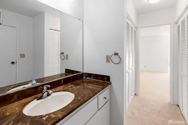 a white bath tub sitting next to a white toilet and sink
