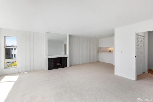 a view of empty room with a fireplace and cabinet