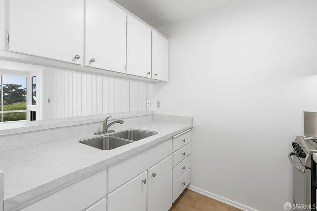a kitchen with a sink and cabinets