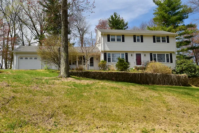 a front view of house with yard and trees