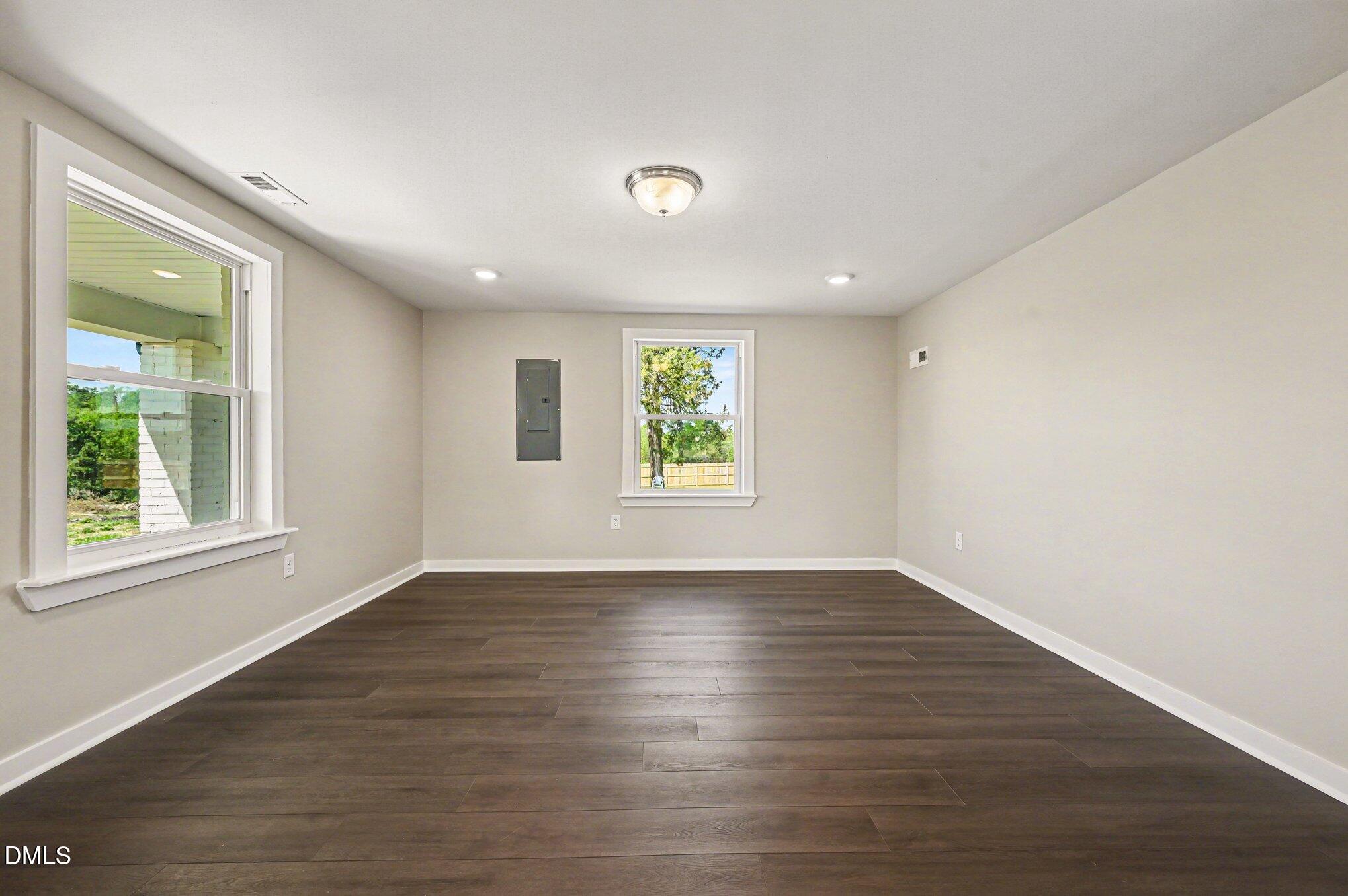 1325 Charlie Carr Road Roxboro, NC 27574 - Photo 11 of 31 an empty room with wooden floor and windows