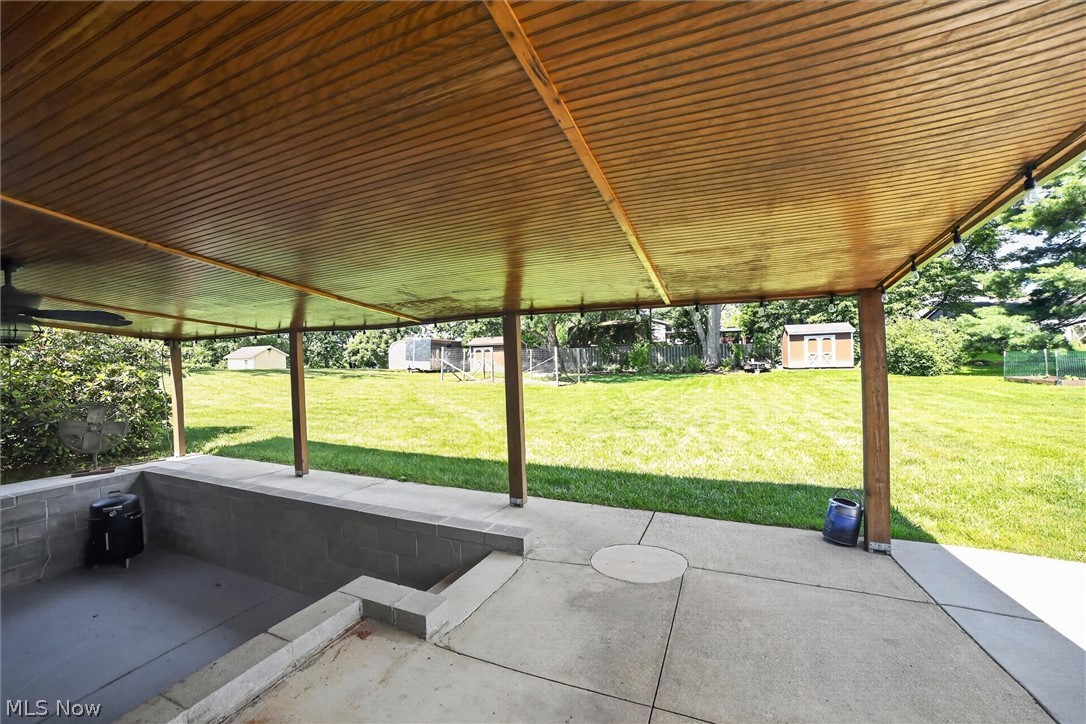 5862 Canterbury Road New Franklin, OH 44319 - Photo 32 of 45 Patio area with additional concrete pad for outside entertaining and or parking of boat. 2 sheds in background each at 10 X 12 for mowers, bikes etc.