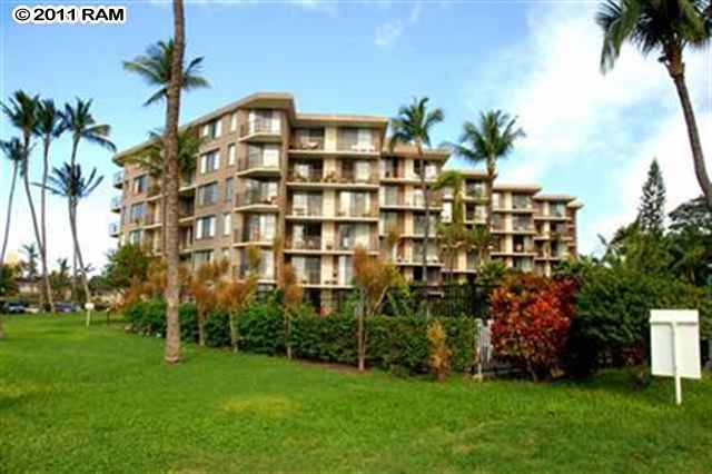 a front view of a multi story building with yard