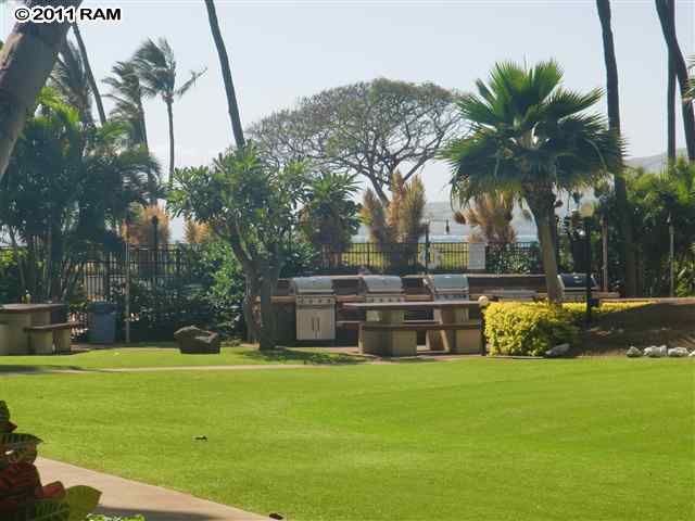 938 South Kihei Road, Unit 122 Kihei, HI 96753 - Photo 4 of 7 a house view with swimming pool and trees in the background