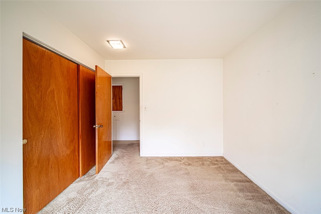 2323 Rockefeller Road Wickliffe, OH 44092 - Photo 15 of 34 Unfurnished bedroom featuring a closet and light colored carpet