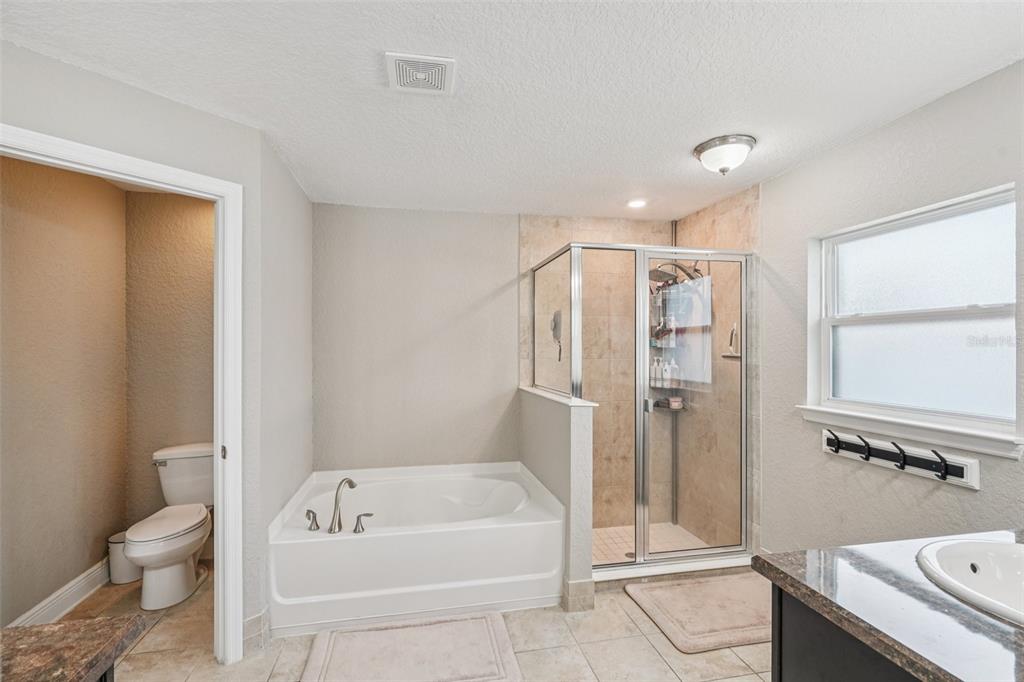 9846 Southwest 55th Ave Road Ocala, FL 34476 - Photo 15 of 25 a bathroom with a tub a toilet and a sink
