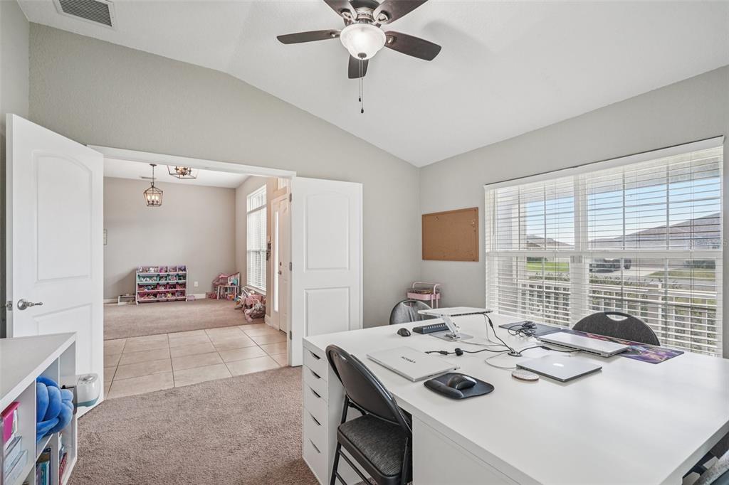 9846 Southwest 55th Ave Road Ocala, FL 34476 - Photo 21 of 25 a view of kitchen island a sink windows and a dining table