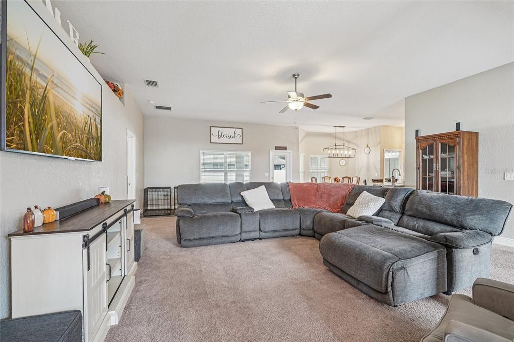 9846 Southwest 55th Ave Road Ocala, FL 34476 - Photo 4 of 25 a living room with furniture and a lamp