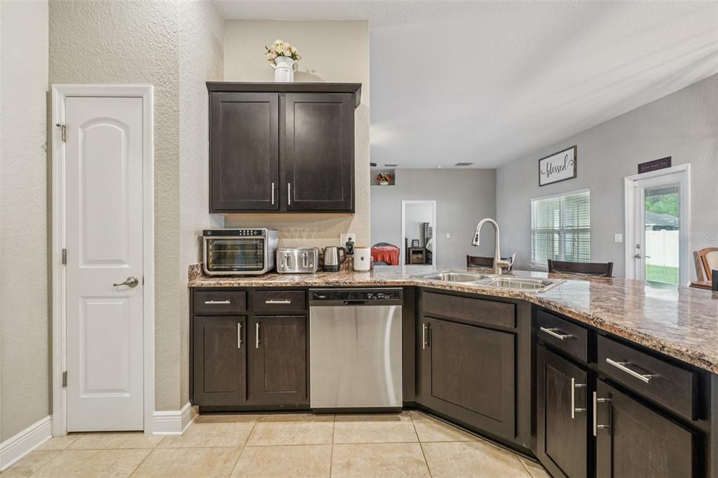 9846 Southwest 55th Ave Road Ocala, FL 34476 - Photo 10 of 25 a kitchen with a sink and cabinets