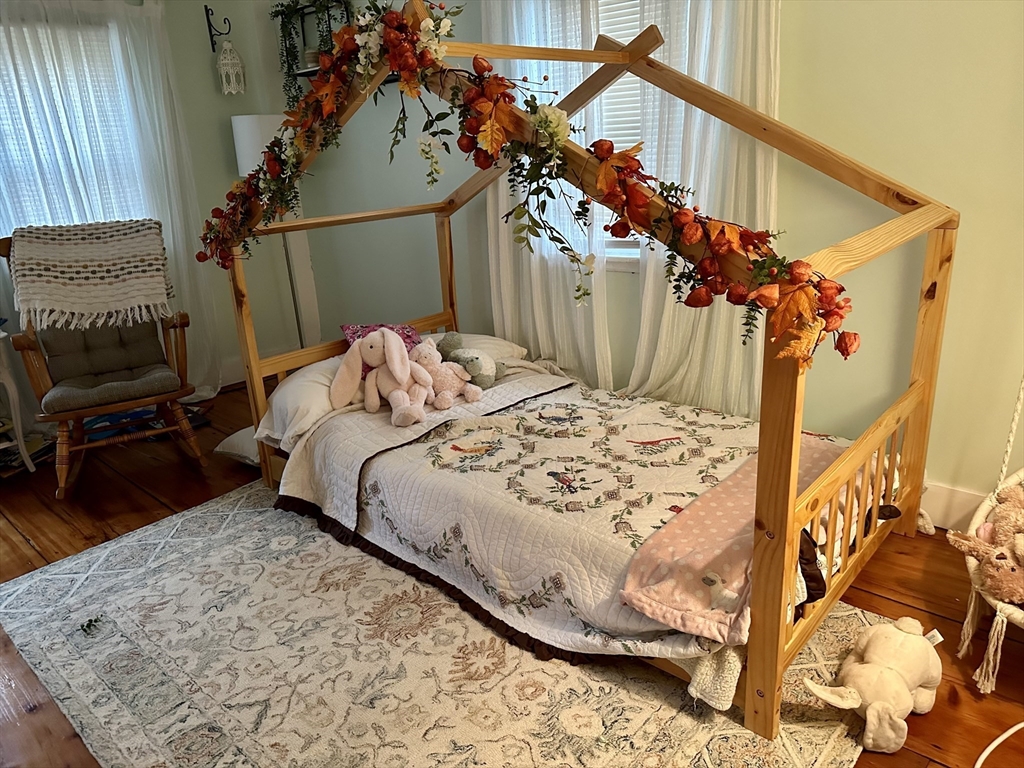 2208 Washington Street Canton, MA 02021 - Photo 10 of 15 a bed sitting in a bedroom next to a window