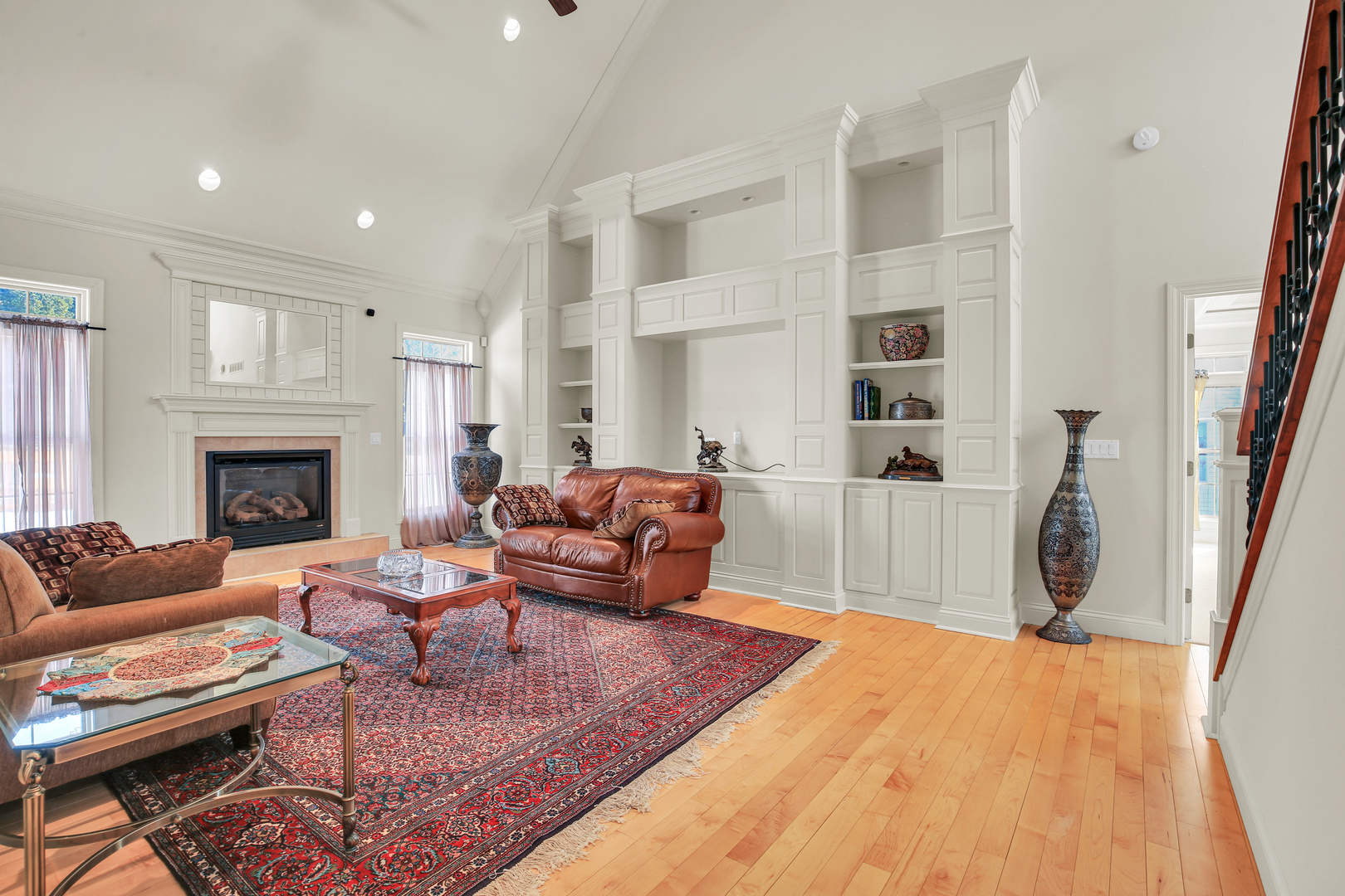 2202 Strand Drive Champaign, IL 61822 - Photo 11 of 62 a living room with furniture a fireplace and a flat screen tv