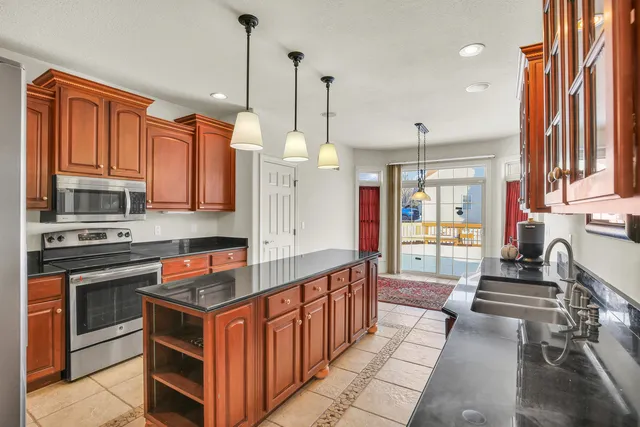 a kitchen with stainless steel appliances granite countertop a stove and a microwave