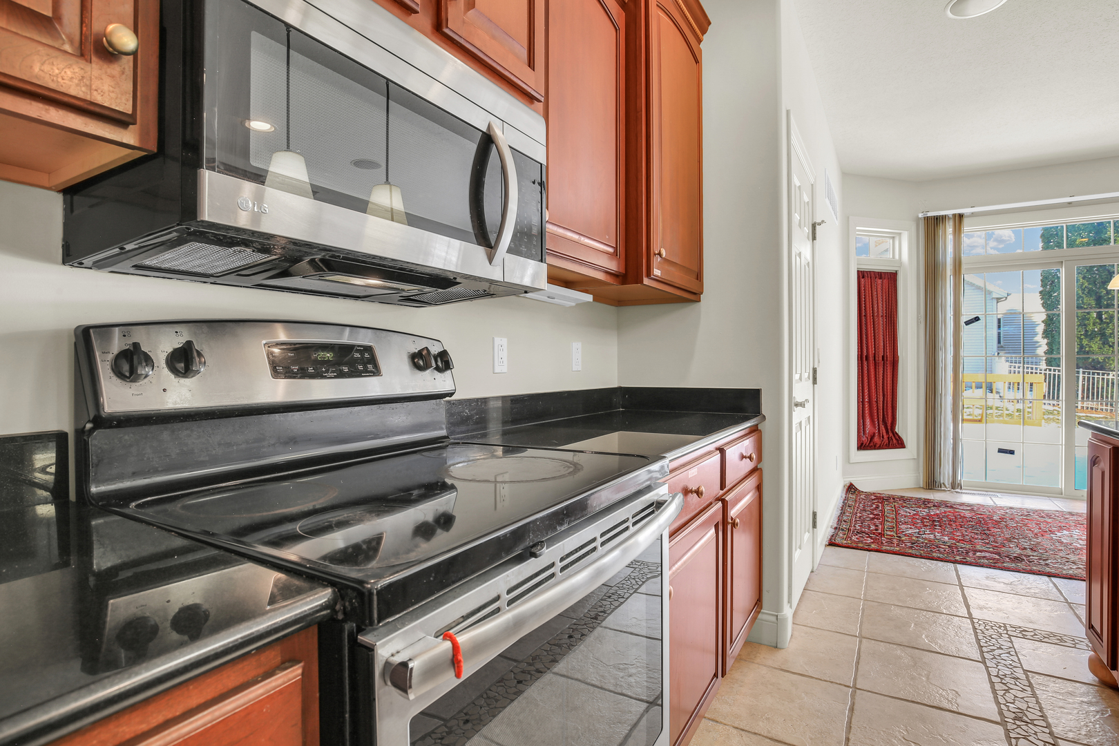2202 Strand Drive Champaign, IL 61822 - Photo 18 of 62 a kitchen with stainless steel appliances granite countertop a stove and a microwave