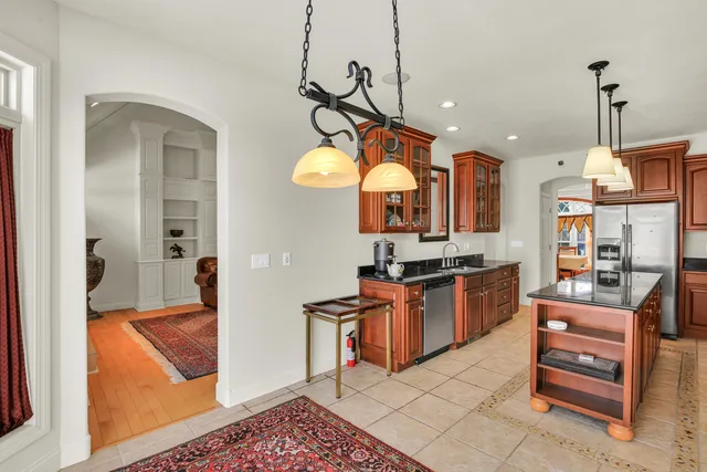 en empty room with windows and cabinet