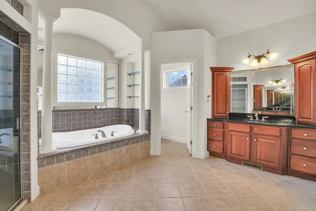 a bathroom with a granite countertop sink toilet and shower