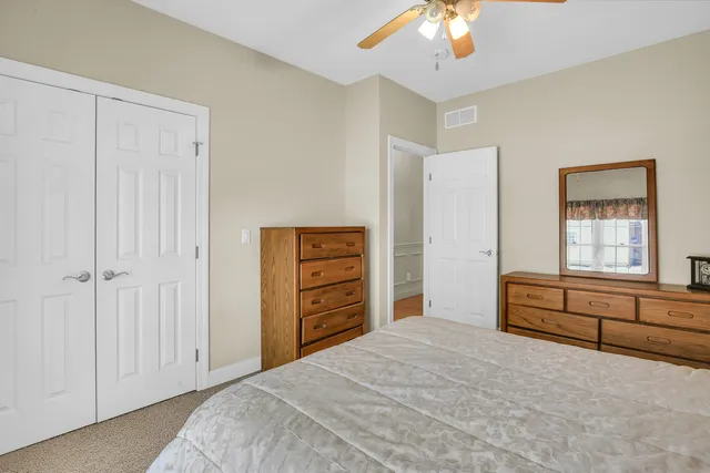 a room with stainless steel appliances kitchen island a table and chairs in it