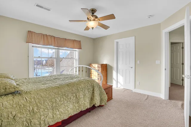 a view of a white house with a snow in the yard