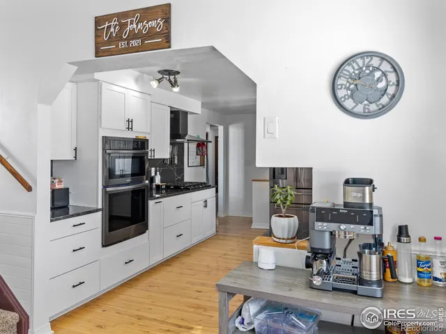 a kitchen with stainless steel appliances a stove a sink and cabinets