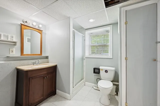 a bathroom with a toilet sink and mirror
