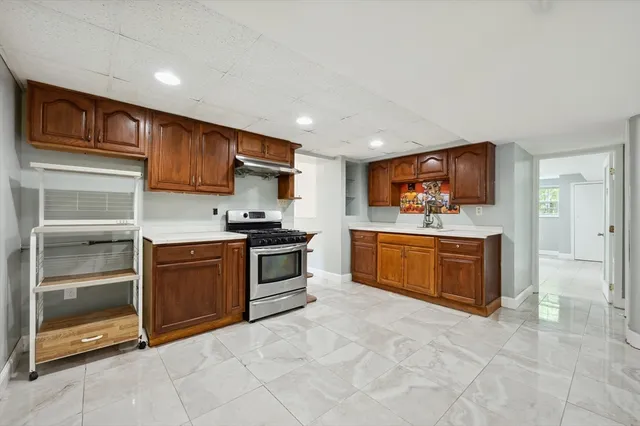 a kitchen with stainless steel appliances a stove sink and cabinets