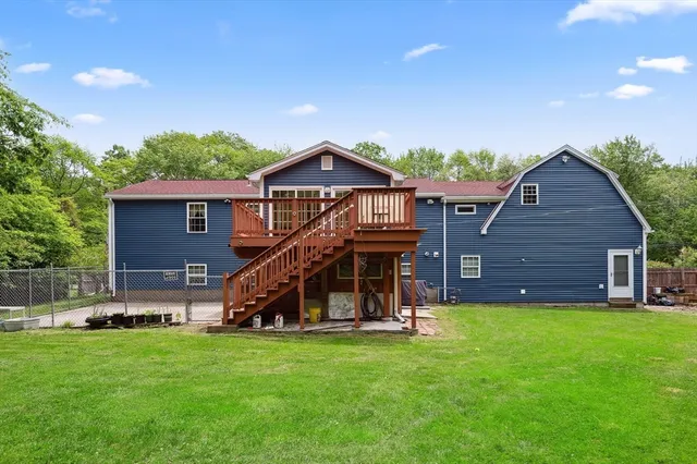 a view of a house with a backyard and a slide