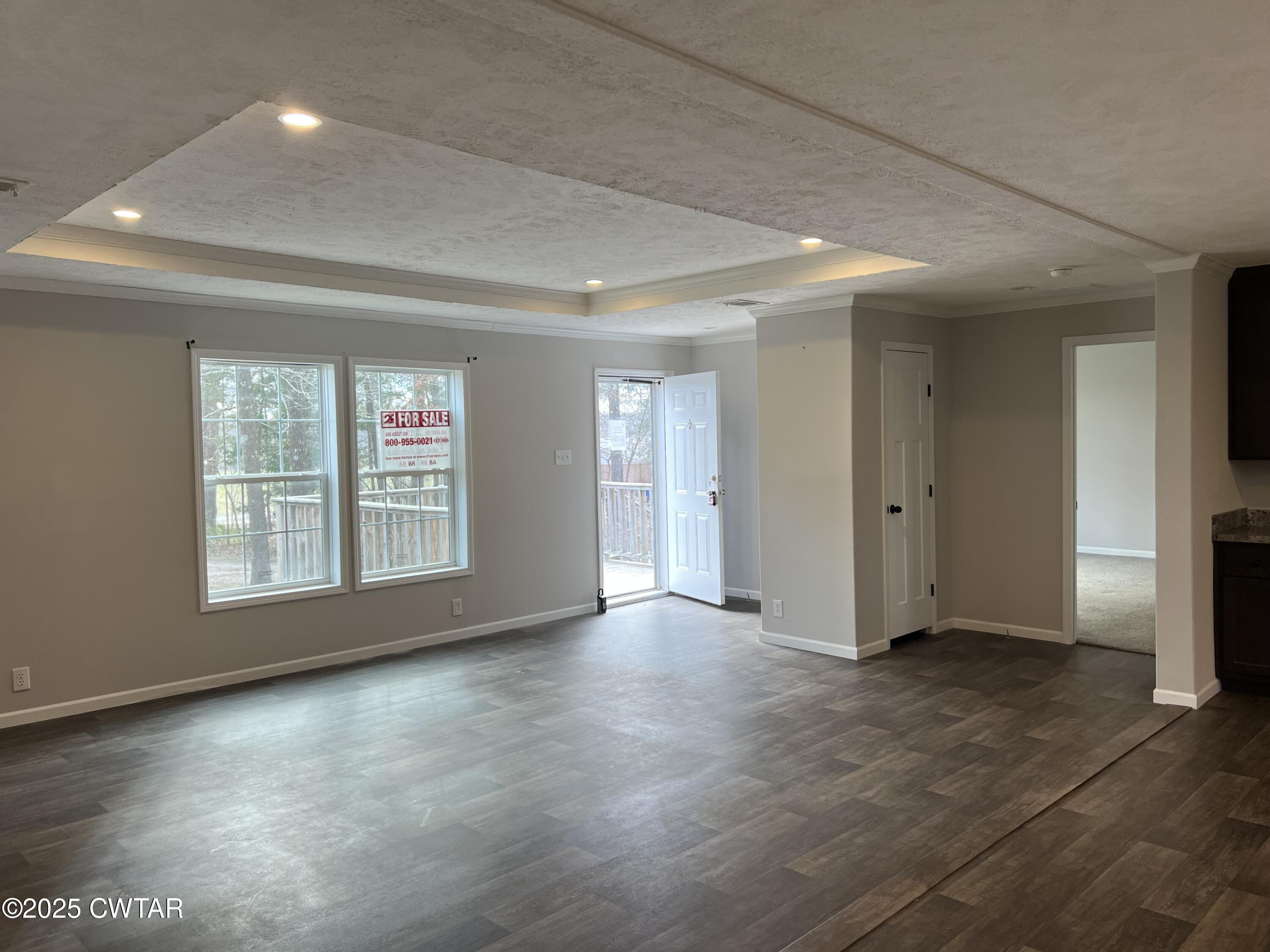 80 Simmons Road Pinson, TN 38366 - Photo 12 of 32 an empty room with wooden floor and windows