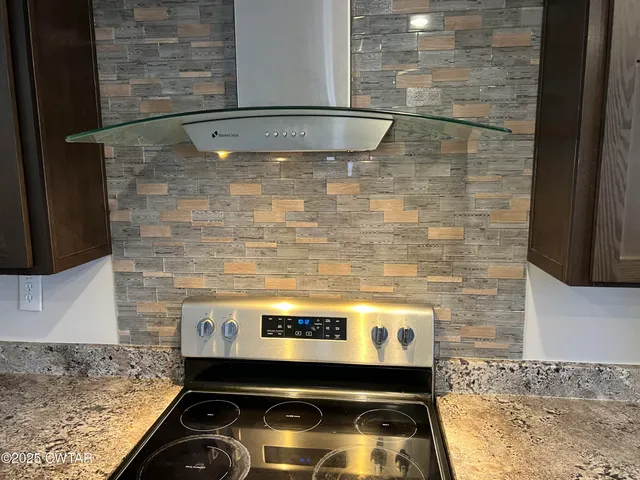 a stove top oven sitting inside of a kitchen
