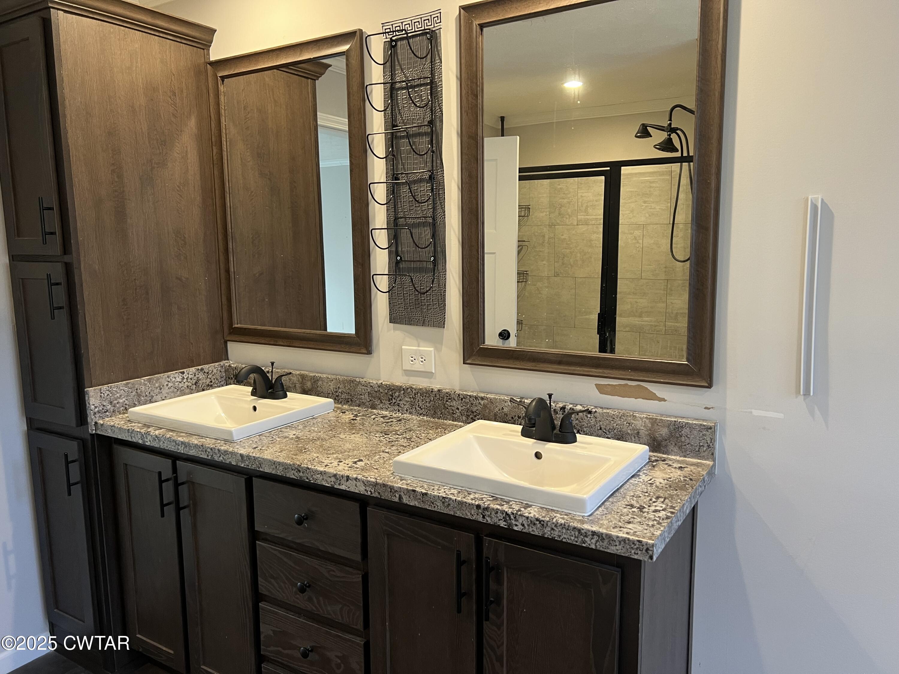80 Simmons Road Pinson, TN 38366 - Photo 16 of 32 a bathroom with a granite countertop sink and a mirror