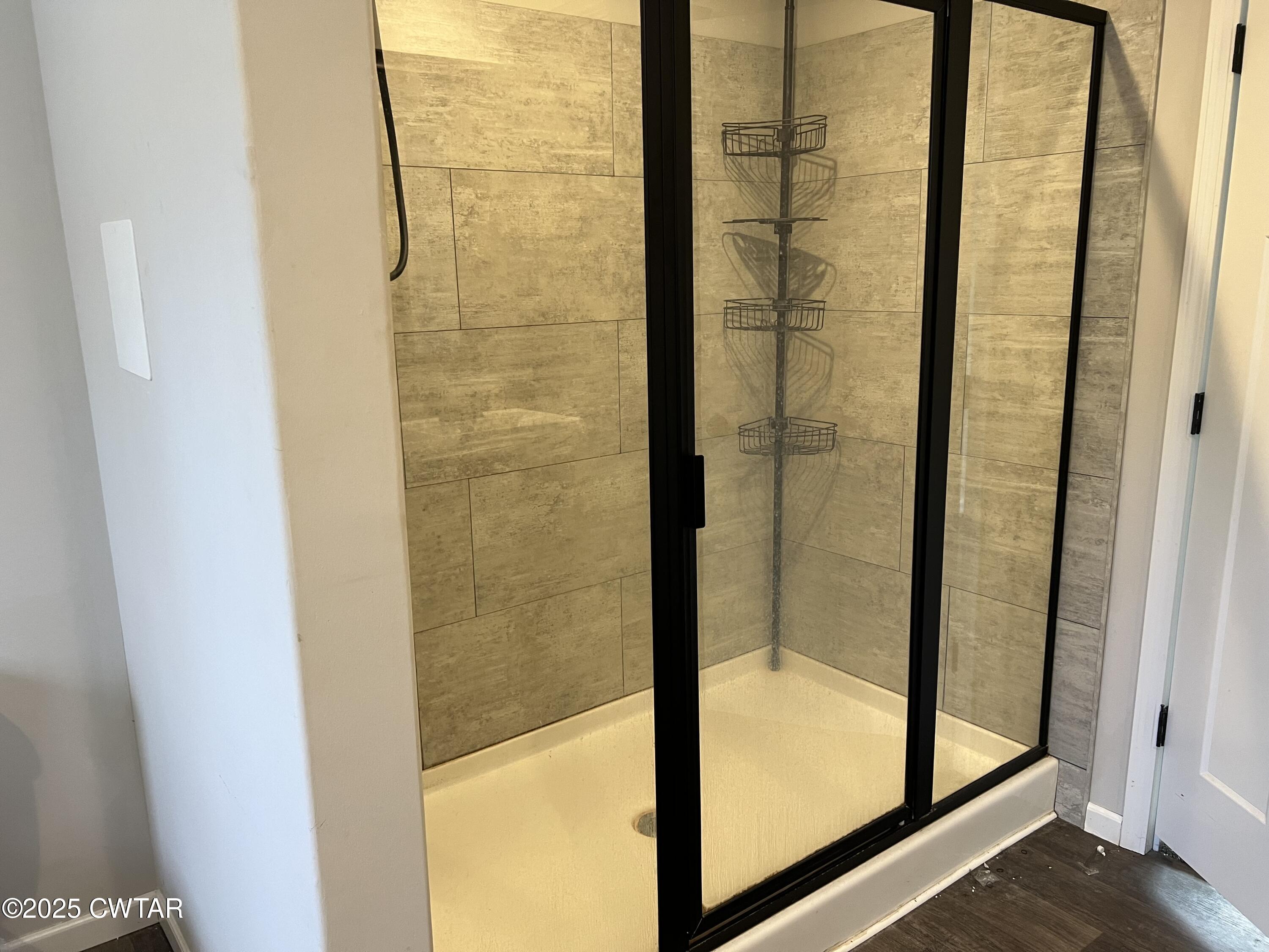 80 Simmons Road Pinson, TN 38366 - Photo 17 of 32 a bathroom with a glass shower door