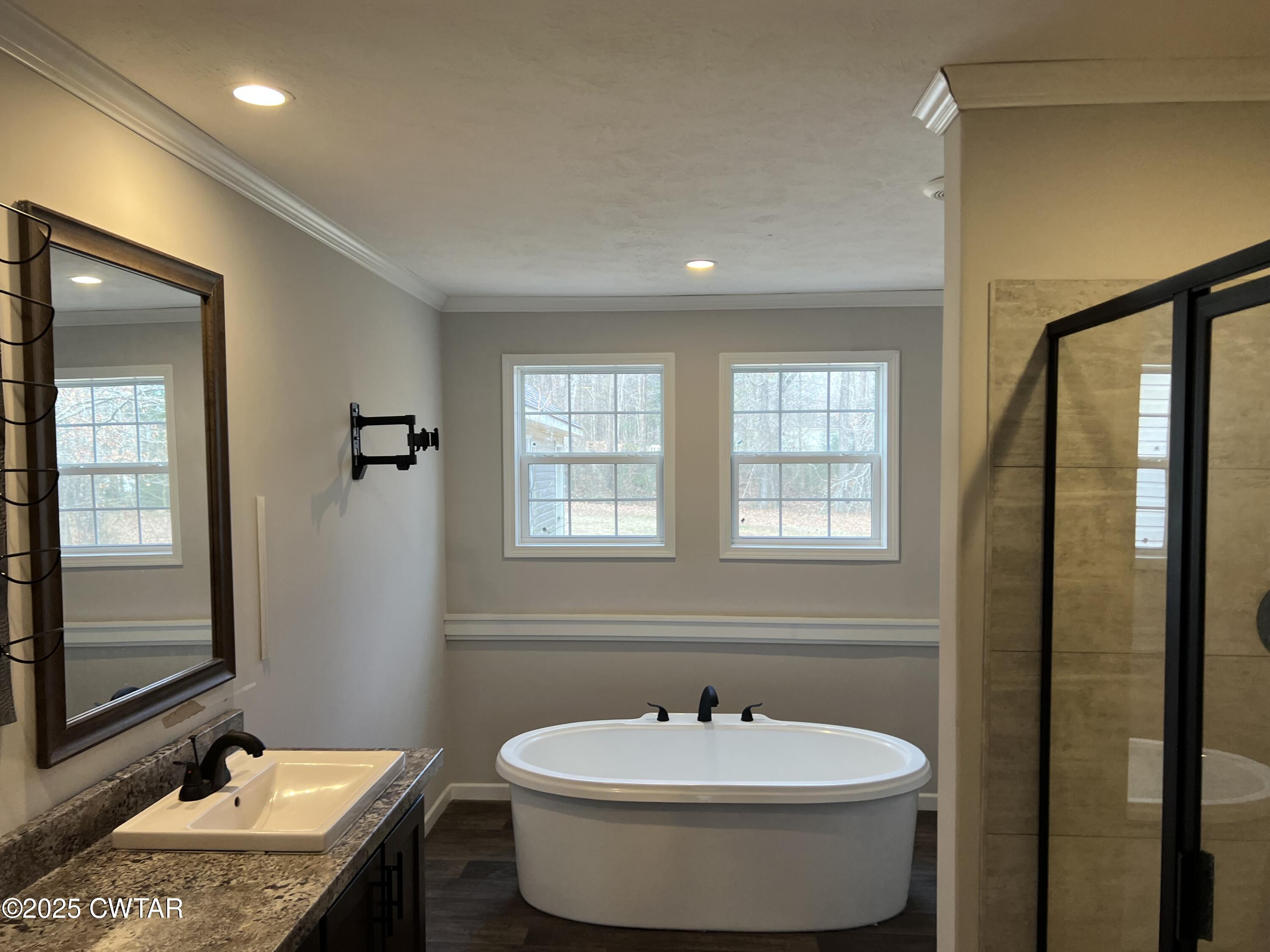 80 Simmons Road Pinson, TN 38366 - Photo 20 of 32 a bathroom with a granite countertop sink and a mirror