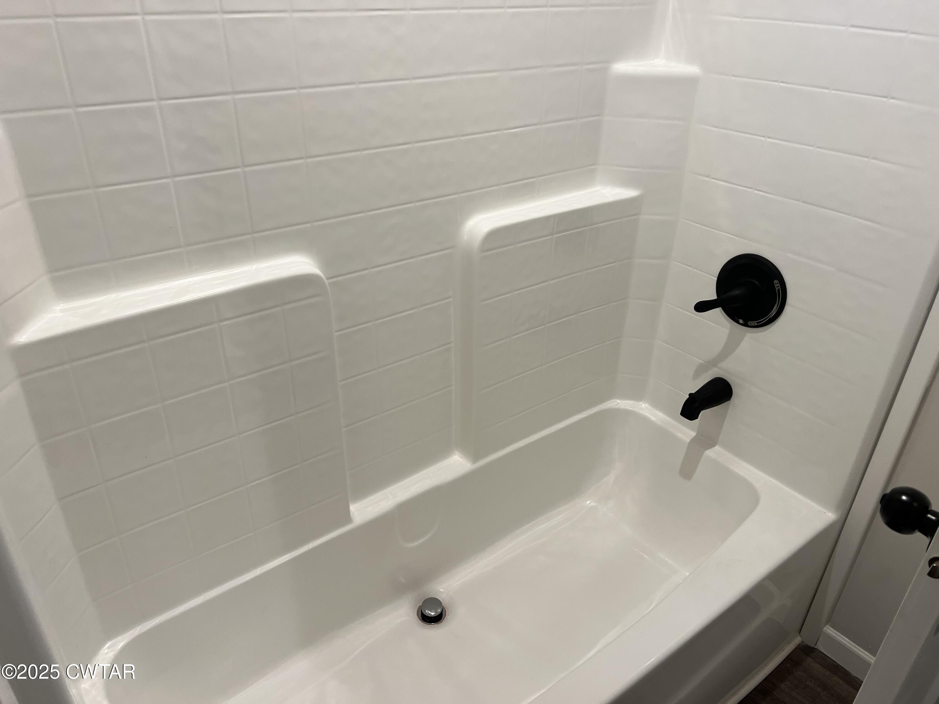 80 Simmons Road Pinson, TN 38366 - Photo 26 of 32 a bathroom with a tub