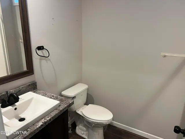 a white toilet sitting next to a bathroom sink
