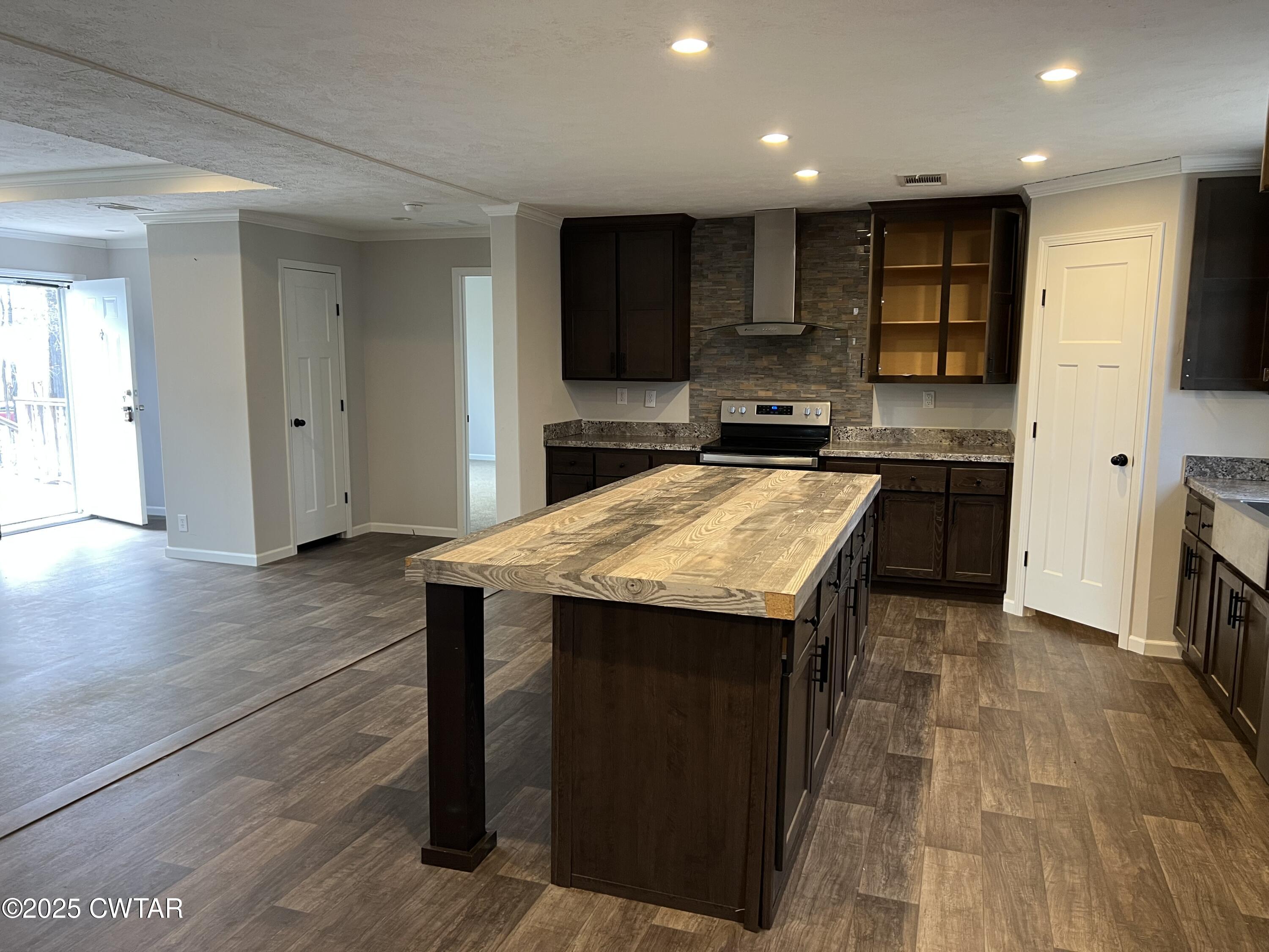 80 Simmons Road Pinson, TN 38366 - Photo 8 of 32 a kitchen with stainless steel appliances granite countertop a table chairs sink and cabinets