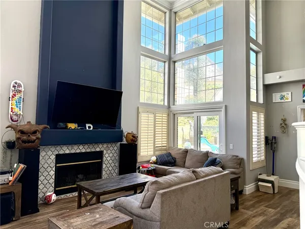 a living room with furniture a flat screen tv and a fireplace