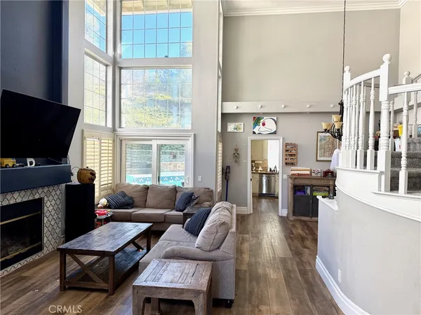 a living room with furniture a flat screen tv and a fireplace