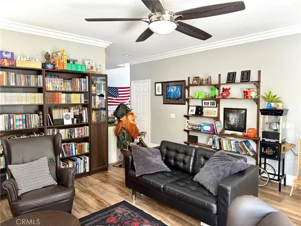 a living room with furniture and a book shelf
