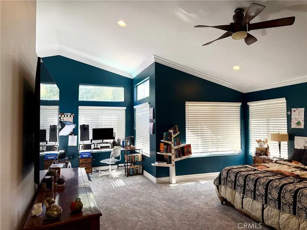 a bedroom with furniture window and a flat screen tv