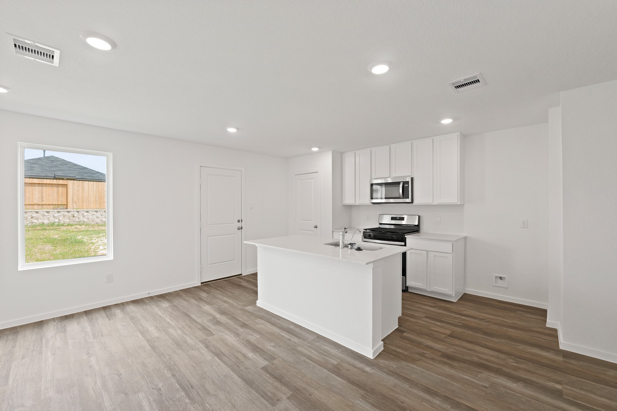 11759 Ruffian Drive Willis, TX 77318 - Photo 1 of 20 a kitchen with stainless steel appliances granite countertop a stove a sink and a refrigerator