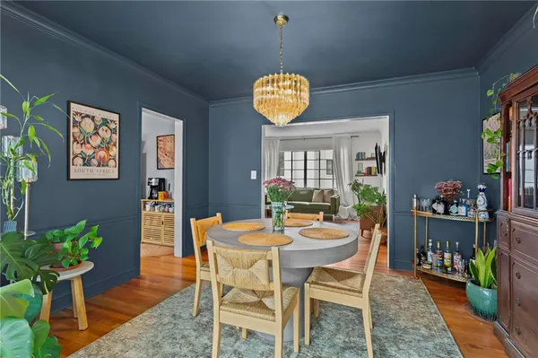 a dining room with furniture and wooden floor