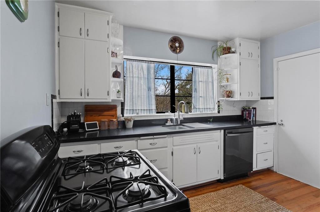 1120 Briarcliff Road Northeast, Unit 3 Atlanta, GA 30306 - Photo 16 of 29 a kitchen with stainless steel appliances a stove a sink and white cabinets