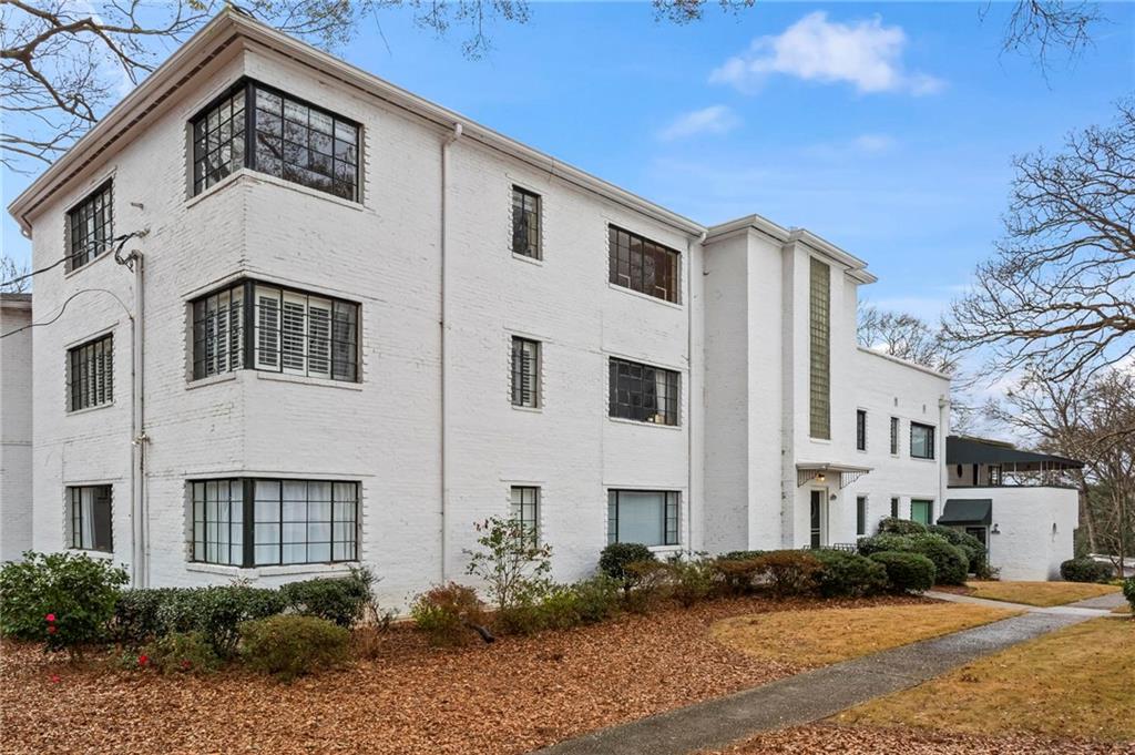 1120 Briarcliff Road Northeast, Unit 3 Atlanta, GA 30306 - Photo 23 of 29 a front view of a house with a yard