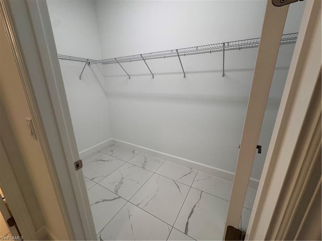2864 Bloomfield Way Naples, FL 34112 - Photo 21 of 40 a view of a room with racks on the wall