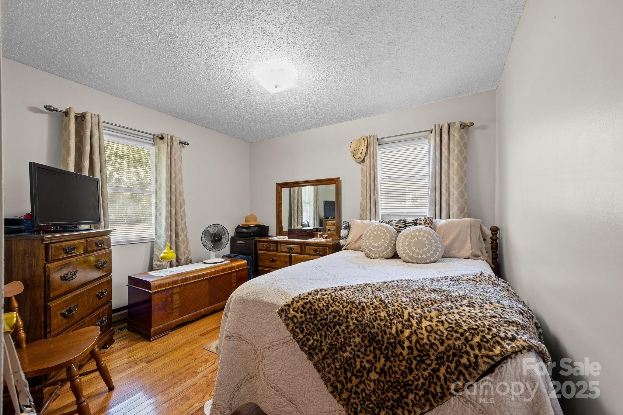 204 Cedar Hill Road Asheville, NC 28806 - Photo 13 of 25 a bedroom with a bed and flat screen tv