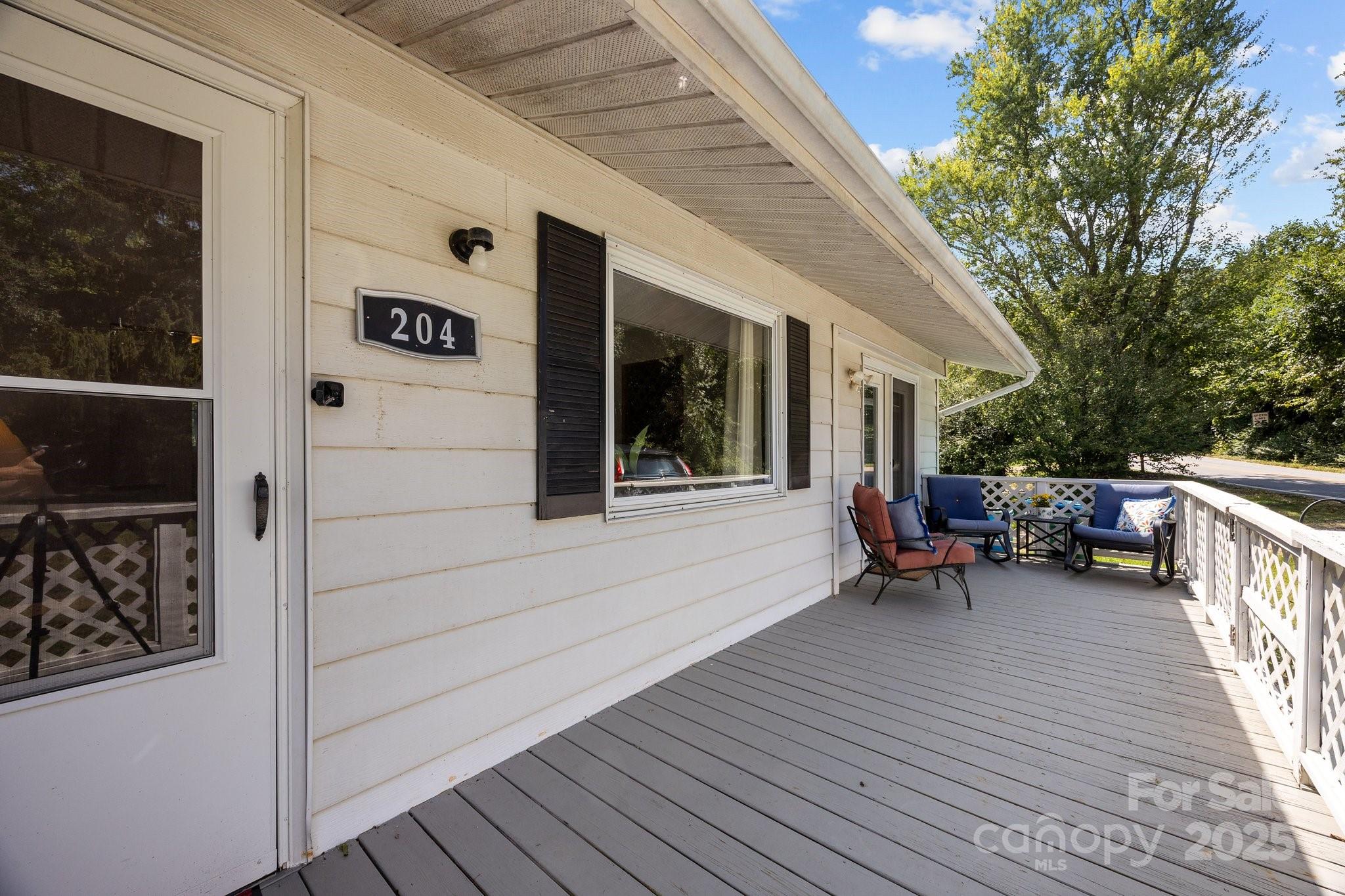 204 Cedar Hill Road Asheville, NC 28806 - Photo 21 of 25 a view of a deck with table and chairs and wooden floor