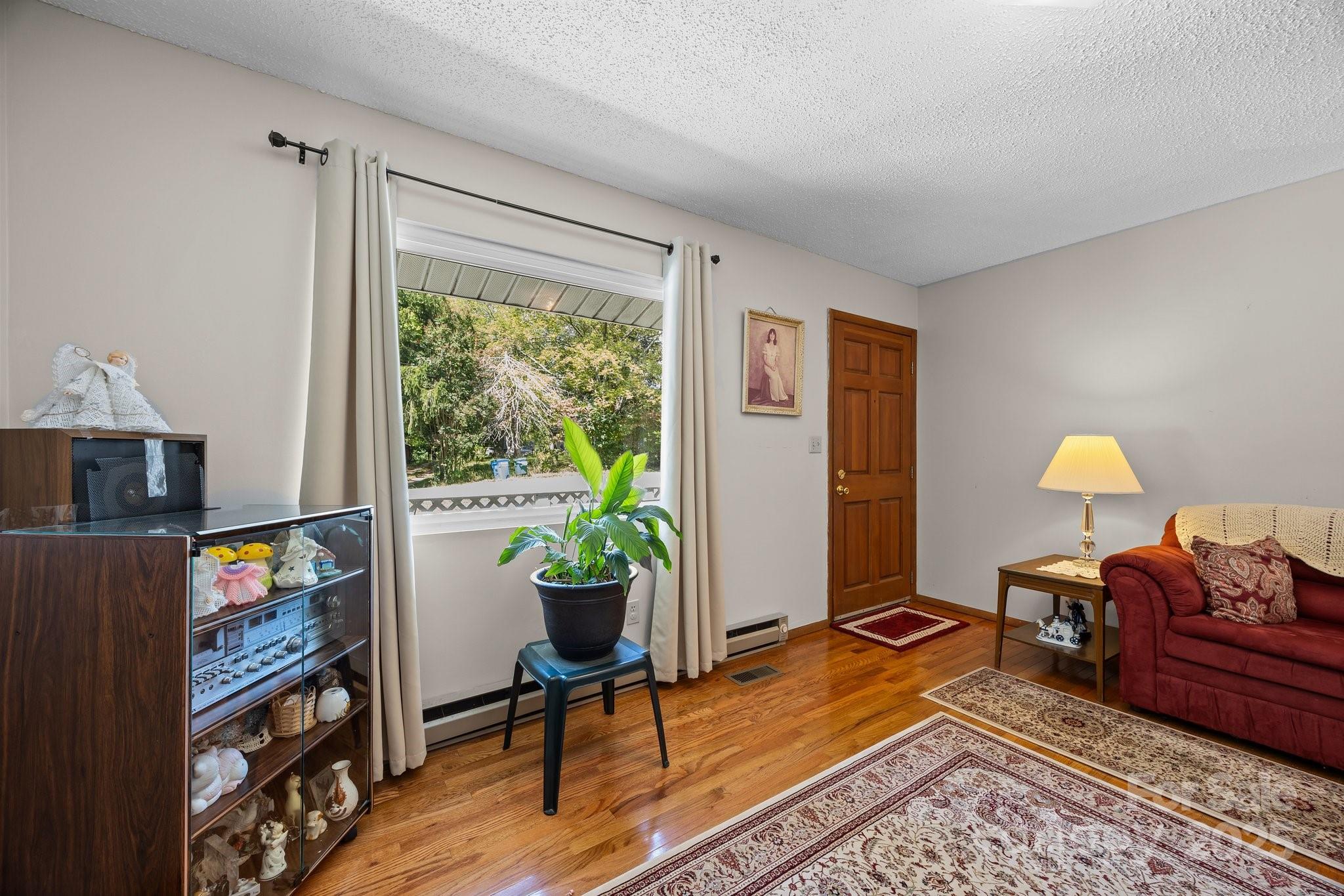 204 Cedar Hill Road Asheville, NC 28806 - Photo 4 of 25 a workspace with furniture and a potted plant