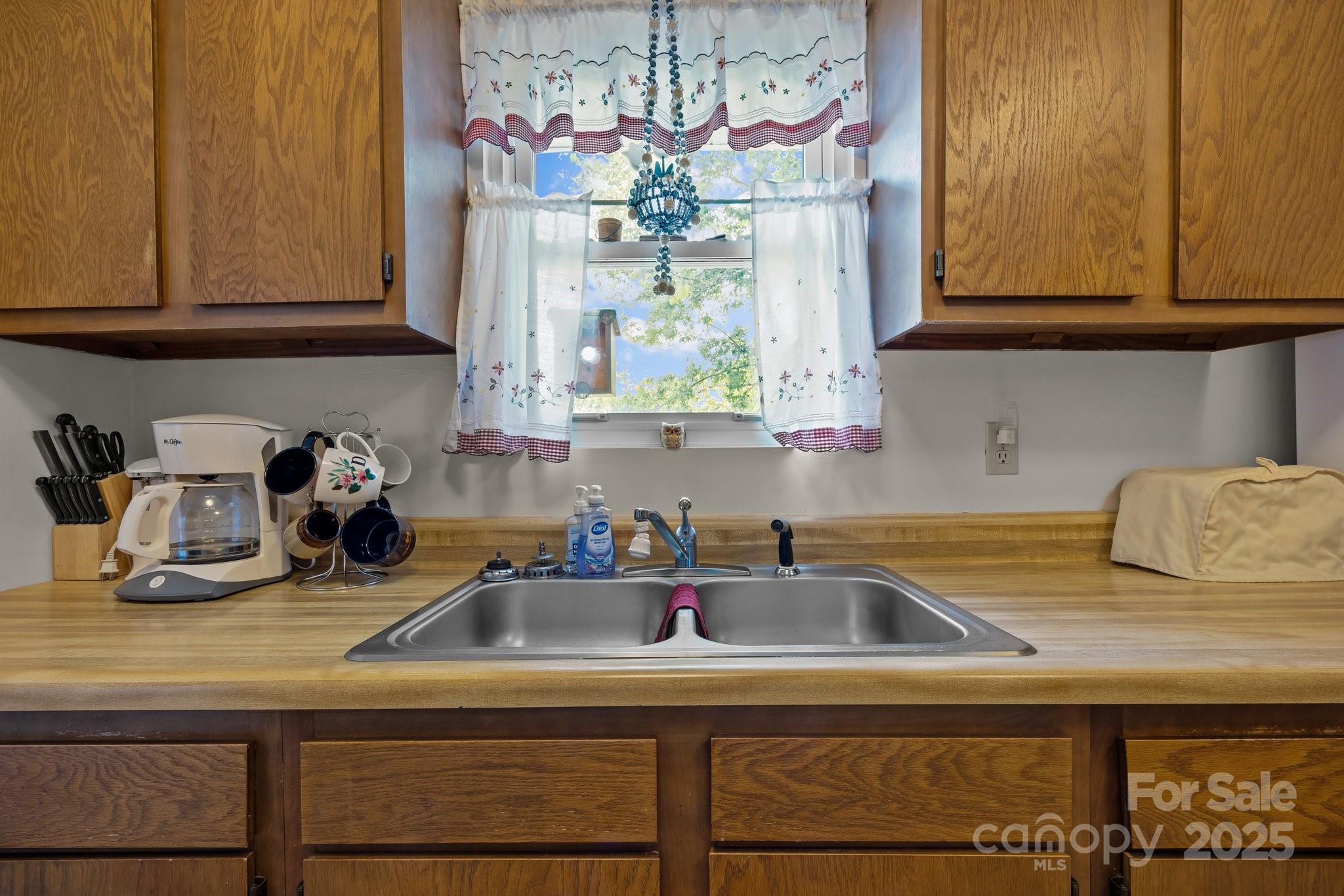 204 Cedar Hill Road Asheville, NC 28806 - Photo 6 of 25 a kitchen with a sink and cabinets