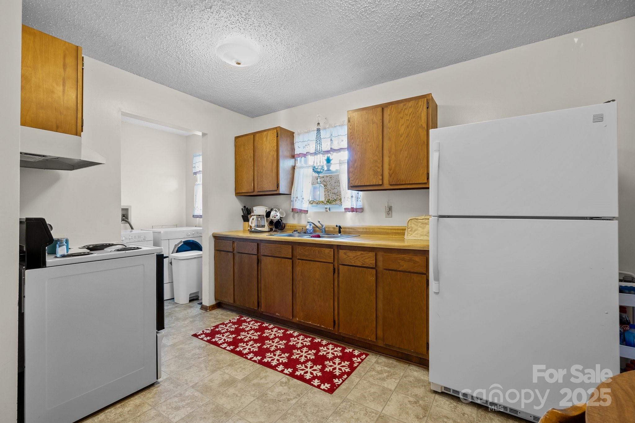 204 Cedar Hill Road Asheville, NC 28806 - Photo 7 of 25 a kitchen with stainless steel appliances granite countertop a refrigerator sink and stove