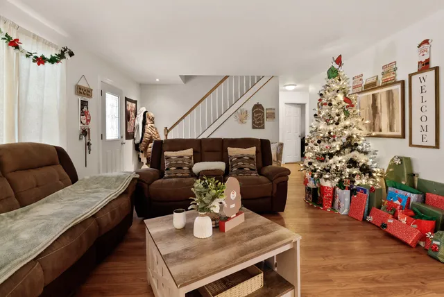 a living room with furniture and flowers